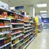 Picture of aisle in supermarket. Products are stacked on shelves on opposite sides